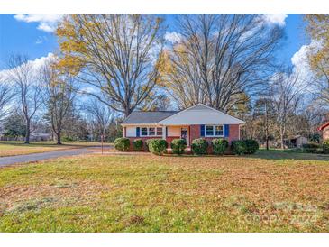 Brick ranch house with a landscaped yard and driveway at 187 Shumaker Dr, Statesville, NC 28625