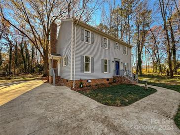 Two-story house with gray siding, brick accents, and a landscaped yard at 2117 Arden Dr, Monroe, NC 28112