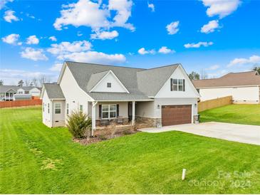 Two-story home with a brown garage door and green lawn at 184 Staffordshire Dr, Statesville, NC 28625