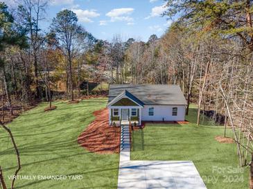 Aerial view of a house with a green yard, and driveway at 2503 Parnell Dr, Shelby, NC 28150