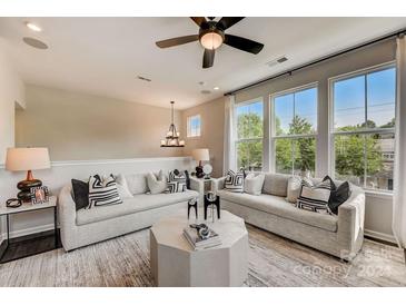 Bright living room with large windows and comfortable seating at 703 Hoke Ln, Davidson, NC 28036