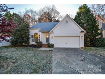 Charming two-story home with a white exterior, attached garage, and landscaped front yard at 9709 Calpher Ct, Matthews, NC 28105