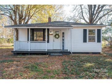 White house with black shutters, front porch, and landscaping at 143 Hallman St, Cherryville, NC 28021