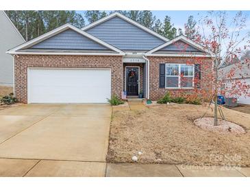 Charming two-story home with a brick and siding exterior, double garage, and landscaped front yard at 2958 Sherrills Stream Dr, Sherrills Ford, NC 28673