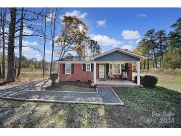 Brick ranch house with gray accents and a covered porch at 1255 W Wall St, Wadesboro, NC 28170