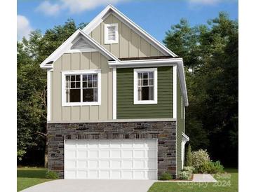 Two-story house with green and beige siding, stone accents, and a two-car garage at 2000 Highland Park Dr, Charlotte, NC 28269