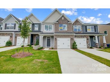 New townhome community with inviting front yards and two-car garages at 6346 Nandina Dr # 160, Harrisburg, NC 28075