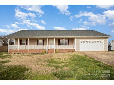 Charming single-story home with front porch and attached garage at 112 Hayworth Ln, Statesville, NC 28625