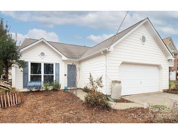 White ranch house with attached garage and landscaping at 7618 Berrywood Cir, Huntersville, NC 28078