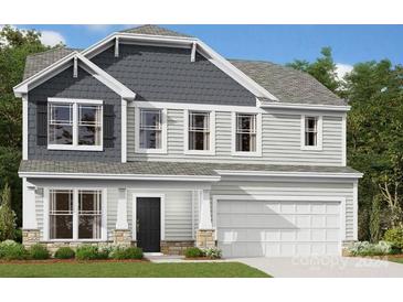 Charming two-story home with gray siding, white trim, and a welcoming front porch at 2612 Clipper Nw Ct, Concord, NC 28027