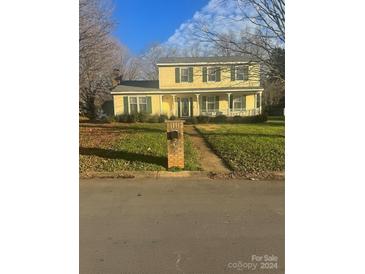 Two-story house with a covered porch and well-maintained lawn at 5401 Dowgate Dr, Charlotte, NC 28208