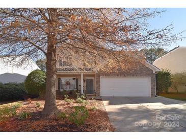 Two-story house with stone accents and a two-car garage at 8717 Sedgeburn Dr, Charlotte, NC 28278