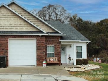 Brick ranch home with attached garage and landscaped front yard at 1663 Golden Cedar Ln, Newton, NC 28658