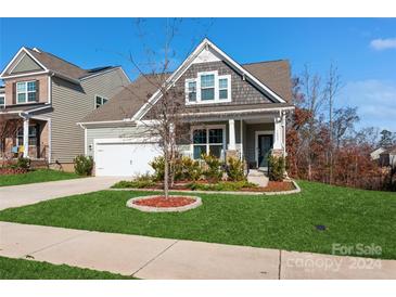 Two-story Craftsman home with gray siding, a white door, and a landscaped front yard at 1052 Willow Bend Dr # 51, Fort Mill, SC 29708