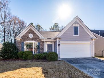 House exterior featuring stone accents and a two-car garage at 8517 Condor Cir, Charlotte, NC 28269