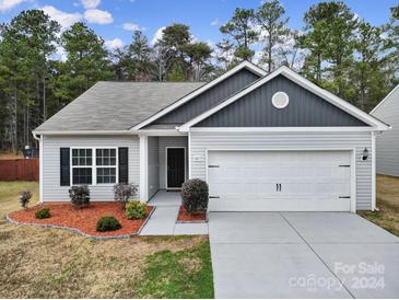 Charming two-story home with gray siding, white trim, and attached two-car garage at 5217 Upton Pl, Charlotte, NC 28215