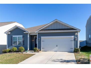 Ranch style home with gray siding, white garage door, and landscaping at 138 Gray Willow St, Mooresville, NC 28117