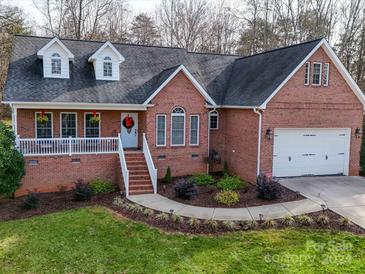 Brick ranch house with attached garage and landscaped yard at 142 Forest Creek Dr, Statesville, NC 28625