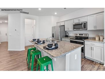 Modern kitchen featuring stainless steel appliances, granite countertops, and an island with bar seating at 524 Trading Post Ln, York, SC 29745