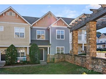 Inviting townhome with a charming front porch and well-maintained landscaping at 10346 Mcgoogan Ln, Charlotte, NC 28277