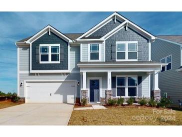 Charming two-story home with a gray and white exterior, front porch, and attached garage at 2133 Clifton Rd, Sherrills Ford, NC 28673