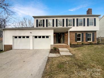 Charming two-story home with a two-car garage, brick and siding exterior, and a welcoming front entrance at 10907 Magenta Ln, Charlotte, NC 28262