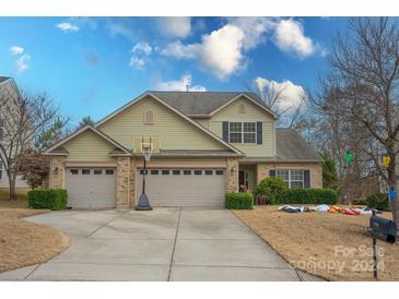 Two-story house with three-car garage, basketball hoop, and landscaping at 1938 Caprington Dr, Fort Mill, SC 29707