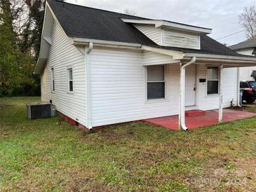 Charming white home with a covered front porch and red accents at 303 Rogers Lake Rd, Kannapolis, NC 28081