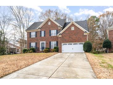 Charming two-story brick home with a two-car garage and landscaped front yard at 11005 Chilcomb Ct, Charlotte, NC 28262