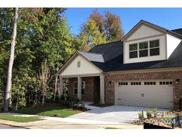 Charming two-story home with a brick and siding exterior, attached garage, and landscaped yard at 3033 Betsy Ross Dr # 29, Gastonia, NC 28056