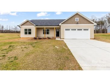 New construction home with a covered front porch, attached two-car garage, and front yard at 8695 Freeze Rd, Kannapolis, NC 28081