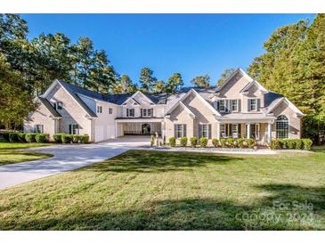 Brick house with a large front yard and attached three-car garage at 335 Blume Rd, Mooresville, NC 28117