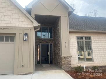 Inviting front exterior of a two-story home with a stone accent wall and covered entryway at 4031 Stadler Ne Dr # 21, Conover, NC 28613