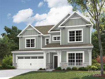 Two-story house with gray siding, stone accents, and a two-car garage at 4675 Hopsack Dr # Cal0107, Indian Trail, NC 28079