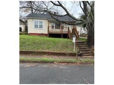 Quaint home with front porch, steps, and grassy yard at 59 Mckinnon Ne Ave, Concord, NC 28025