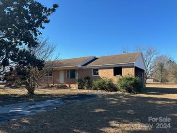 One-story ranch-style home with a brick exterior and attached carport at 835 Baxley Pond Rd, Kershaw, SC 29067