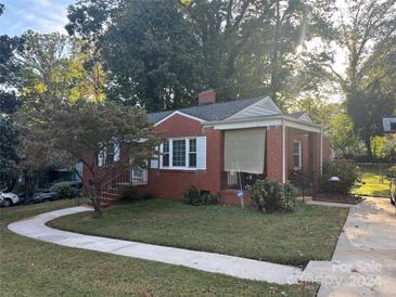 Brick ranch home with landscaped yard and walkway at 2320 Orton St, Charlotte, NC 28208