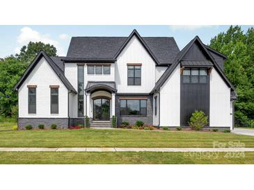 Stunning two-story home with white and black exterior at 10125 Laurier Ln, Huntersville, NC 28078