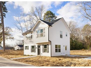 Two-story white house with gray accents and a landscaped yard at 1125 El Paso St, Kannapolis, NC 28083