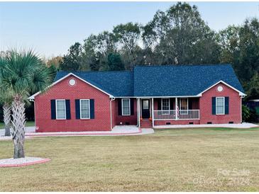 Brick ranch home with a covered porch and landscaped yard at 1361 Fairhope Rd, York, SC 29745