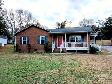 Brick ranch house with front porch, red door, and blue shutters at 212 Camp Rotary Rd, Gastonia, NC 28052