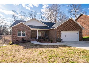 Brick ranch house with 2-car garage, front porch, and landscaped yard at 1533 Weatherwood Dr, Lincolnton, NC 28092