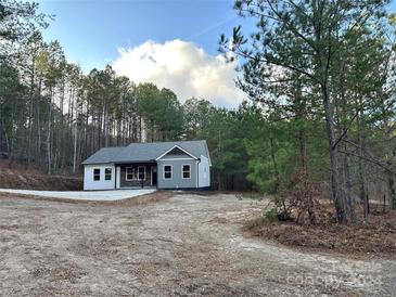 Newly constructed home with gray siding, stone accents, and a gravel driveway at 6767 Nathan Ave, Kannapolis, NC 28081