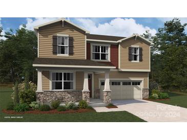 Two-story house with stone accents, two-car garage, and landscaped yard at 1447 Honey Trl, Monroe, NC 28112