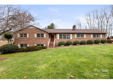 Brick ranch house with a spacious lawn and mature trees at 1496 Arden Dr, Lincolnton, NC 28092