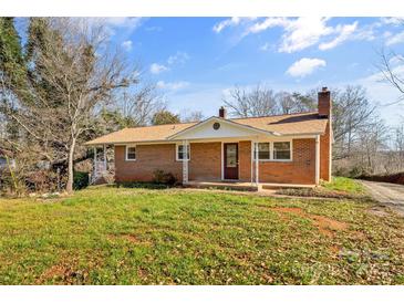 Brick ranch house with a covered porch and a spacious lawn at 3100 Nc Hwy 18 Hwy, Vale, NC 28168