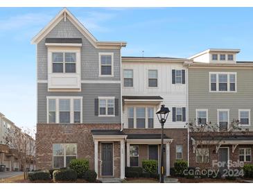 Brick front exterior of charming townhome with gray siding and dormers at 840 Imperial Ct, Charlotte, NC 28273