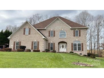 Brick two-story house with brown shutters, and a well-manicured lawn at 1107 Fox Chase Dr, Newton, NC 28658