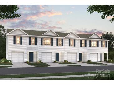 Front view of a charming three-unit townhome building with attached garages at 1935 C Tranquility Cir, Newton, NC 28658