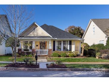 Charming yellow house with brick accents and a welcoming front porch at 6635 Old Magnolia Ln, Mint Hill, NC 28227